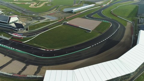 Corners on a race track with single car driving through fast