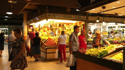 ALICANTE, SPAIN - OCTOBER 08, 2019: Spanish Fruits and Vegetables Central Market Mercado in Alicante, Spain, People Buying Products