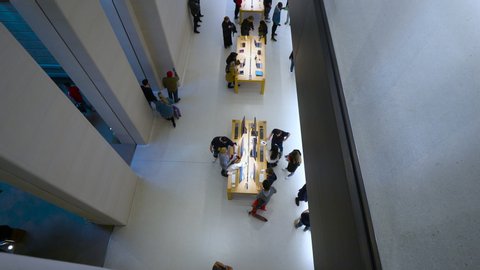 Paris, France - Circa 2019: View from above of Apple Store interior with customers shopping for new iPad iMac Apple Watch and iphones inside the Champs Elysees Computers store