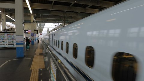HIROSHIMA, JAPAN - SEPTEMBER 14, 2018: Shinkansen train leaving the station in Hiroshima. Japan's highspeed railway lines are famous for fast service and punctuality