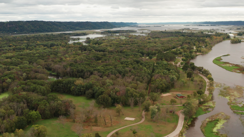 Aerial view of Upper Mississippi river system (bottomland forests, open water, wetlands and islands) at Wisconsin Minnesota border. Autumn fall season (october). Scenic  landscape from above, drone sh