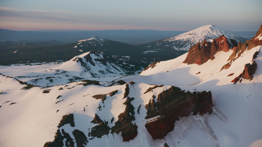 Cascade Mountains, Oregon circa-2019. Aerial view of Sisters Mountains. Shot from helicopter with Cineflex gimbal and RED 8K camera.