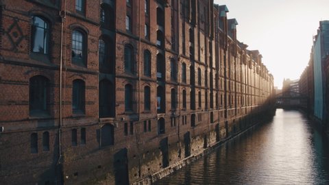 4K Aerial water canal buildings in Hamburg close up, warm colors - Slow Motion