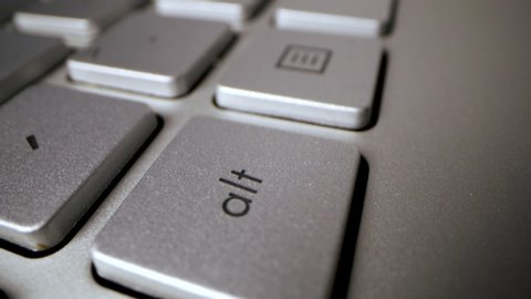 sliding over computer keyboard. finger press the enter key