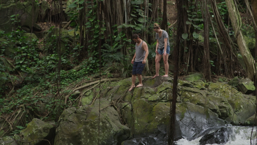 Couple exploring waterfalls in Hawaii