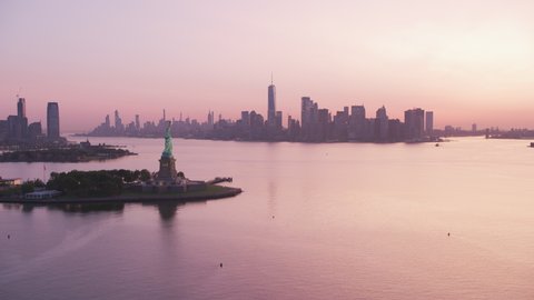 New York City, New York circa-2019. Aerial view of Statue of Liberty at sunrise. Shot from helicopter with Cineflex gimbal and RED 8K camera.