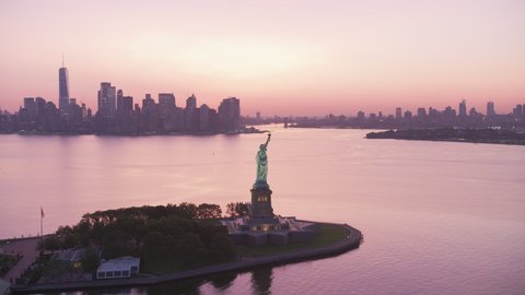 New York City, New York circa-2019. Aerial view of Statue of Liberty at sunrise. Shot from helicopter with Cineflex gimbal and RED 8K camera.