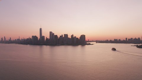 New York City, New York circa-2019. Aerial view of New York City ferry at sunrise. Shot from helicopter with Cineflex gimbal and RED 8K camera.