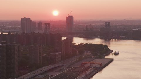 New York City, New York circa-2019. Aerial view of sun rising over New York City. Shot from helicopter with Cineflex gimbal and RED 8K camera.