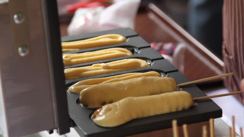 Making food corn dogs in machine electric Royalty-Free Stock Footage #1039119776