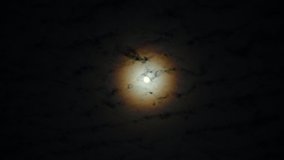 horror full moon with yellow halo behind fast moving clouds - Powered by Shutterstock - Get 15% off with code: PIKWIZARD15