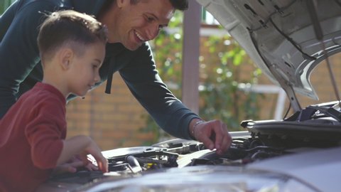 The father and son fixing the car. slow motion