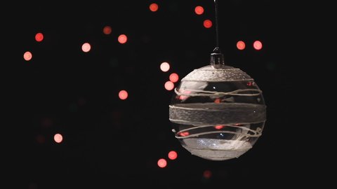 Christmas decorations, ball hanging on the bokeh background of flashing lights.