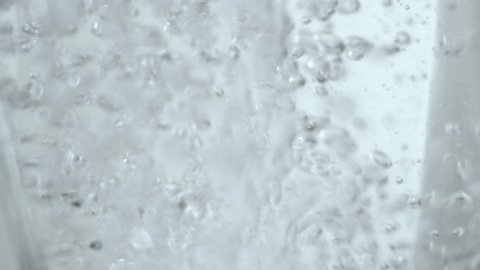 Water bubbling or boiling in a glass container