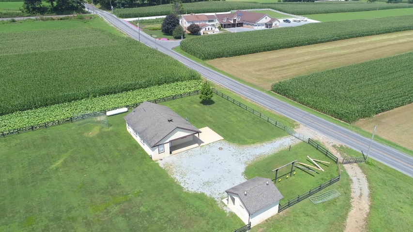 Aerial View of an Amish Farmland with an Amish One Room School House on a Sunny Summer Day