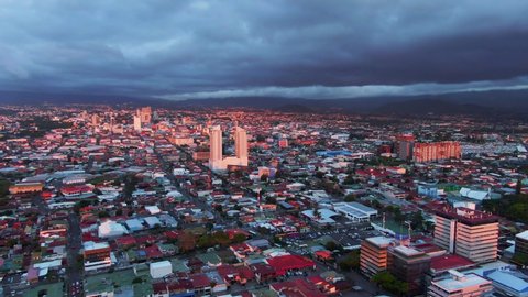 Beautiful cinematic aerial view of the sunset in the city of San Jose Costa Rica