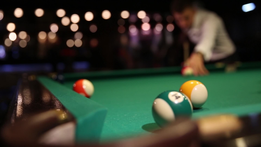 Sports game of billiards on a green cloth. Billiard balls with numbers on a pool table. Billiards team sport. | Shutterstock HD Video #1039173761