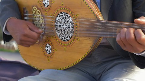Close up of an Arabic oud musical instrument being played by a man in Marrakesh, Morocco, Africa.