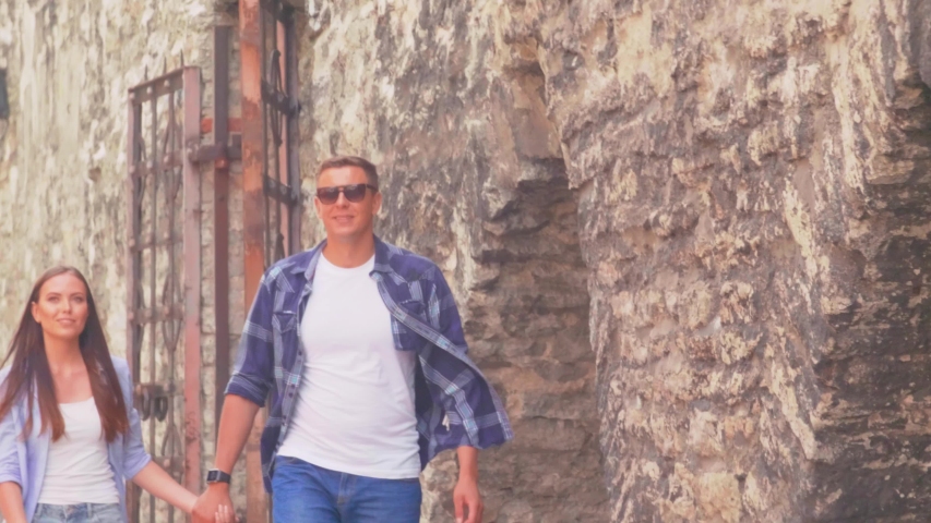 Couple of tourists traveling and exploring beautiful old town. Loving man and woman in a vacation trip.