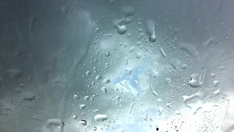 Rain drops on glass with clouds moving motion in rainy day.rain drops on glass clips
