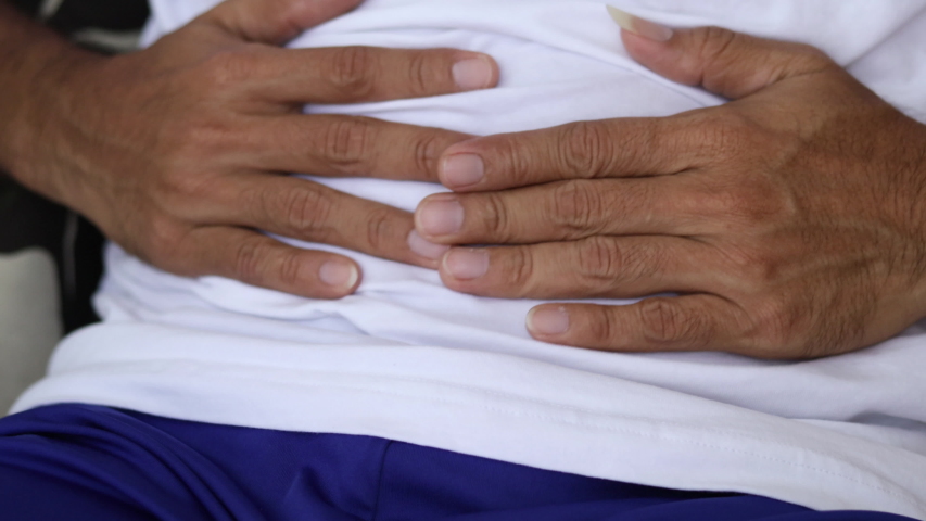 Yuong man holding his stomach in pain