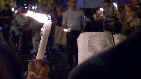 Rome,Italy, 19 July 2018: Reading text during a commemorative procession lighting by a candles. San Lorenzo District,Rome