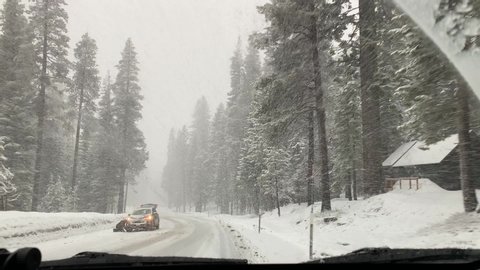 Driving in heavy winter snow weather. White out conditions in South Lake Tahoe's US Highway 50.