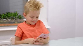 Little blonde boy talks video call his girl friend, using futuristic digital transparent holographic display the latest advanced augmented reality holographic technology. 4k footage