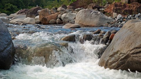 Fresh river water flowing. Clean fresh mountain river flowing between rocks. 4K.