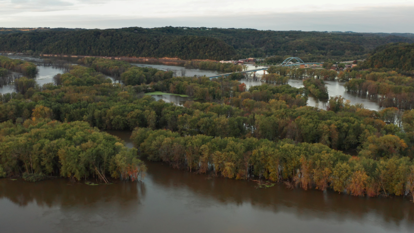 Aerial view of Upper Mississippi river (bottomland forests, open water, wetlands, islands) at Wisconsin Minnesota border. Autumn fall season (october). Landscape from above, drone shot. Sunrise, sunny