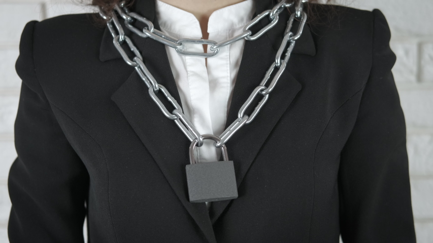 Lock on the neck. A woman in a costume with chain on her neck straightens her lock.