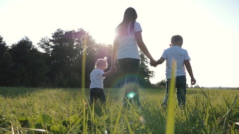 Young Mother Walks Her Children On Stock Footage Video (100% Royalty