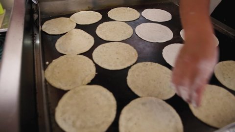 Flour tortillas are being prepared on a hot plate