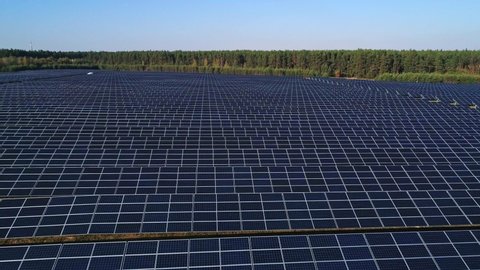 Aerial drone footage. Flight over solar panel farm. Renewable green alternative energy