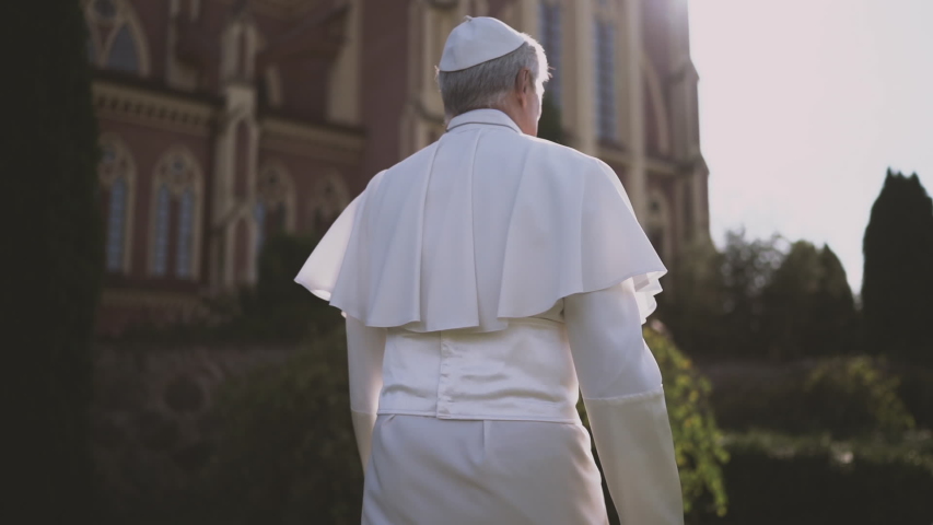 Religion: Pope walks through the Vatican garden at sunset. Slow motion | Shutterstock HD Video #1039246994