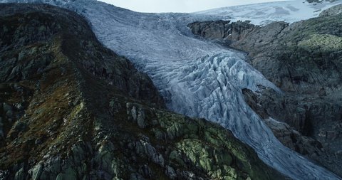 Aerial shot across glacial crevices in ice tongue. Folgefonna blue ice glacier. Norway.