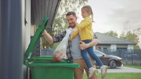 Happy Father Holding a Young Girl and Going to Throw Away an Empty Bottle and Food Waste into the Trash. They Use Correct Garbage Bins Because This Family is Sorting Waste and Helping the Environment. - Powered by Shutterstock - Get 15% off with code: PIKWIZARD15