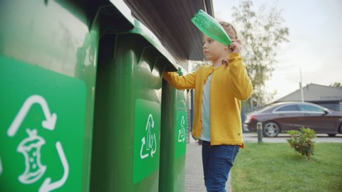 Young Girl is Walking Outside Her House in Order to Throw Away an Empty Plastic Bottle into a Trash Bin. She Uses Correct Garbage Bin Because This Family is Sorting Waste and Helping the Environment.
