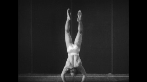 1940s: Muscular man in a Speedo gracefully performs balancing exercises including a handstand. An animation of his skeleton is superimposed on his body.