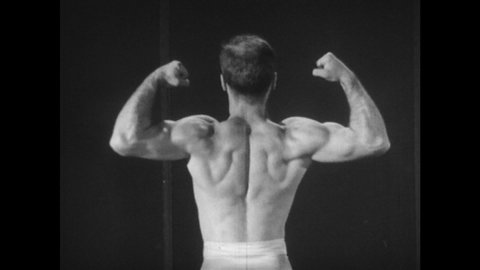 1940s: Muscular man in a Speedo turns and shows his back. Man flexes his biceps and back muscles. Close-up of a bicep flexing and relaxing. Superimposition of arm bones on the flexing bicep.