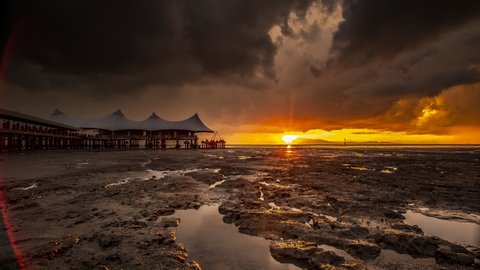Time lapse of Sunset at Kuala Perlis, Malaysia. Showing moving and changing colour clouds as the sun setting. Prores 4k. Selected focus.