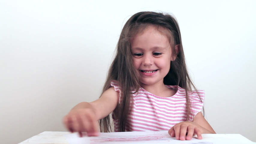 Little five years old girl drawing and crumple a piece of paper