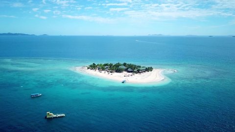 aerial shot, flying and tilt towards a paradise island in Fiji