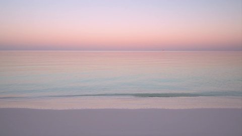 Calm waters and a beautiful pink dawn sky at one of the most beautiful beaches in the world 