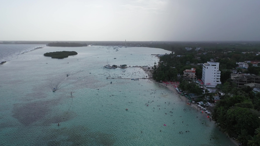 Aerial Drone view of Dominican republic Boca Chica beach nearby Santo Domingo city. People enjoying holiday on the beach in caribbean sea with crystal clear water.