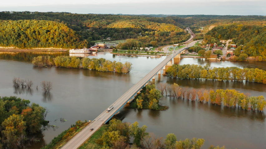 Aerial view of Upper Mississippi river (bottomland forests, open water, wetlands, islands) at Wisconsin Minnesota border. Autumn fall season (october). Landscape from above, drone shot. Sunrise, sunny