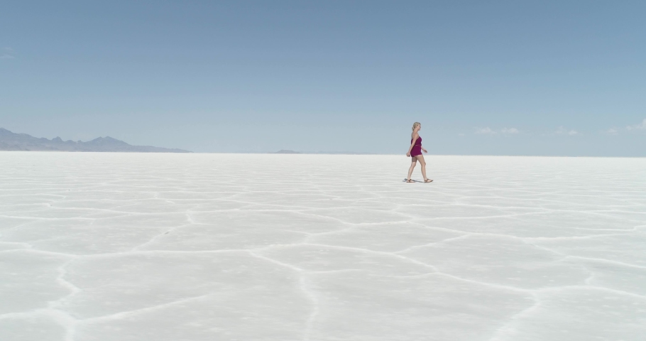 Beautiful Blonde Woman Walks on Salt Flats Aerial Side View from Drone (Utah)