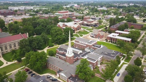 Aerial view of the Hope College campus in Holland, Michigan. Drone moves forward over red brick buildings.