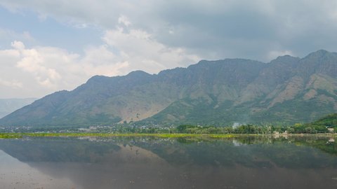 4K Time lapse of moving clouds over Dal Lake in Kashmir, India. The urban lake, which is the second largest in the union territory, is integral to tourism and recreation in Kashmir. Zoom In
