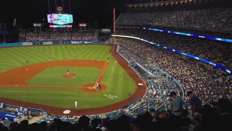 Los Angeles , California / United States - 09 29 2019: Dodgers baseball Stadium in Los Angeles California. Panning shot across stands with fans overlooking diamond.